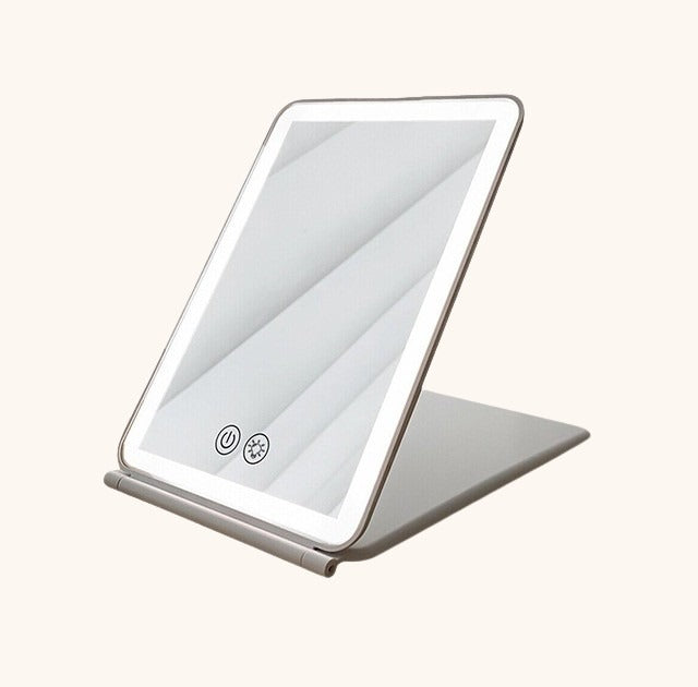 Folding makeup LED mirror with 80 bright lights, portable and compact design.